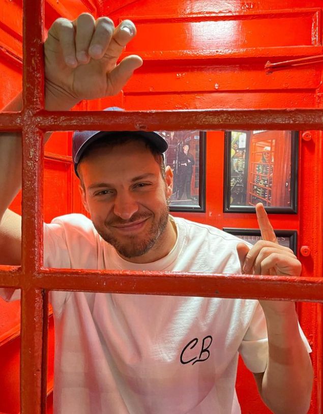 Vito Coppola in a white shirt and red booth