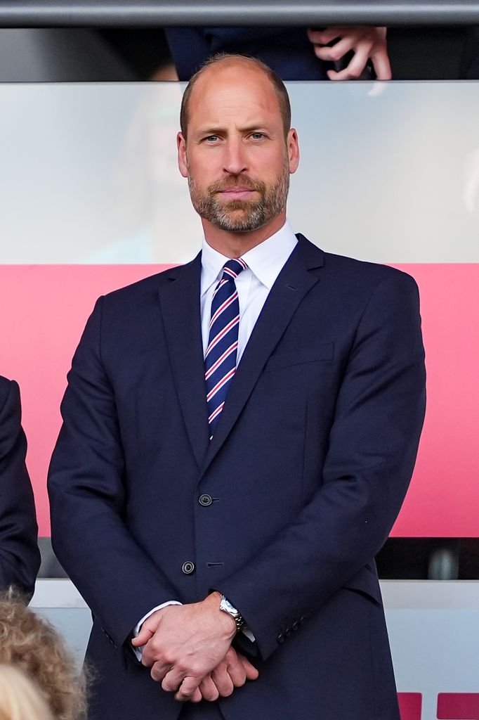 Prince William in suit watching football