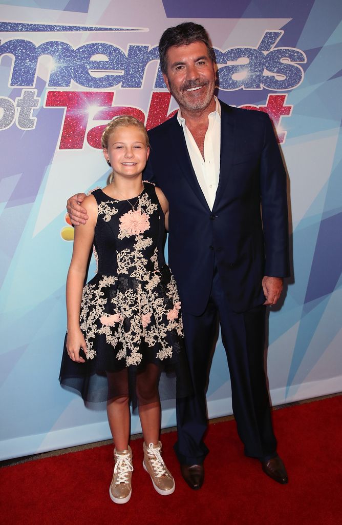 The twelthest relay winner -ventiloquist Darci Lynne Farmer (L) and the judge/executing producer Simon Cowell visit NBC's "America has talent" Season 12 final in the Dolby Theater on September 20, 2017 in Hollywood, California