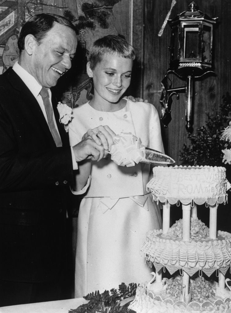 Frank Sinatra and actress Mia Farrow cutting their wedding cake at Las Vegas, 19th July 1966