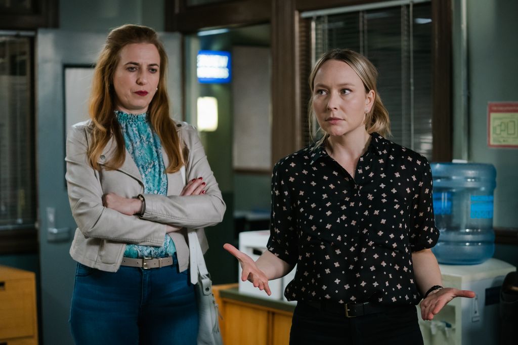 two women standing in office