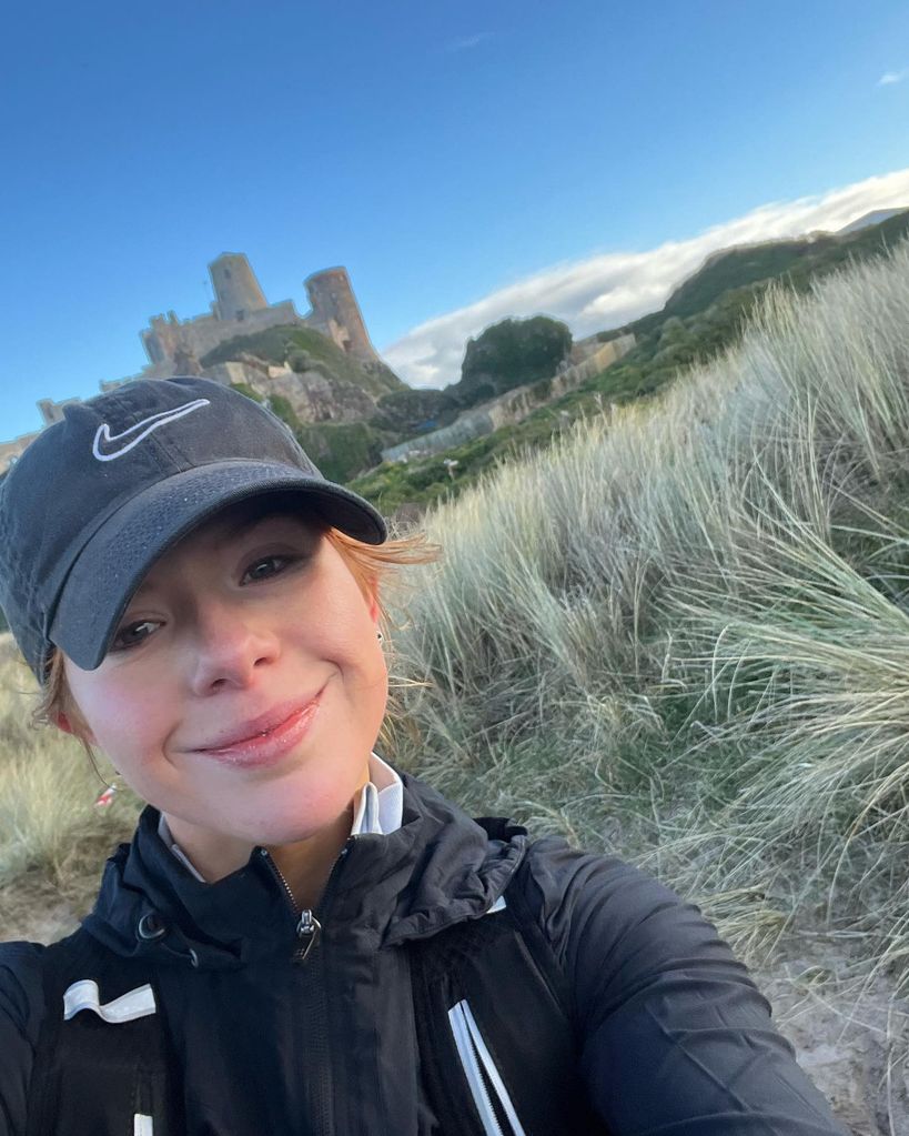 Selfie of a woman with a castle in the background