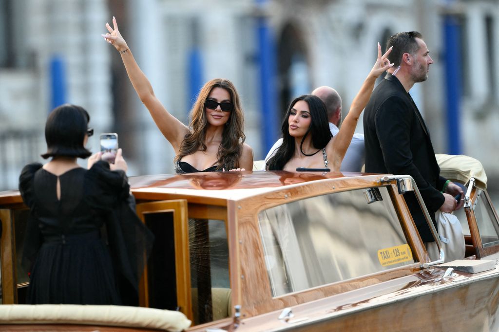 Kris Jenner takes pictures of Khloe Kardashian and Kim Kardashian on a taxi boat as they leave the Gritti Palace Hotel 