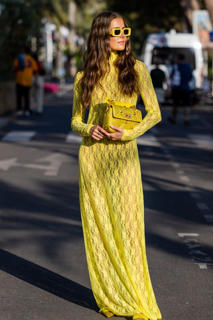 Nina Sandbech gave 'summer goth' in a yellow laced dress, Valentino bag, and tonal court heels