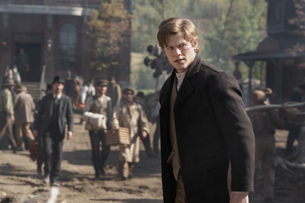 young man standing in busy street