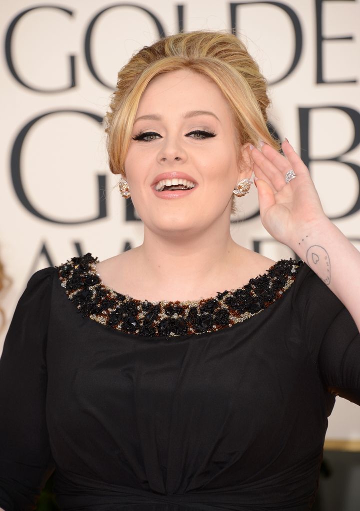 Adele's tattoos can be seen on her wrist 