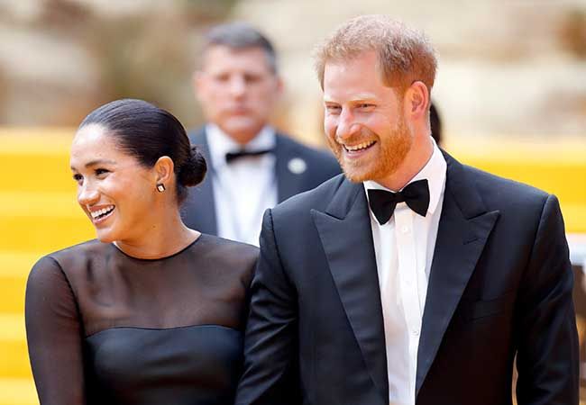 Prince Harry and Meghan Markle laugh together at red carpet event