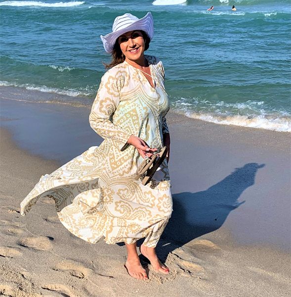 Jane McDonald in flowing dress on the beach