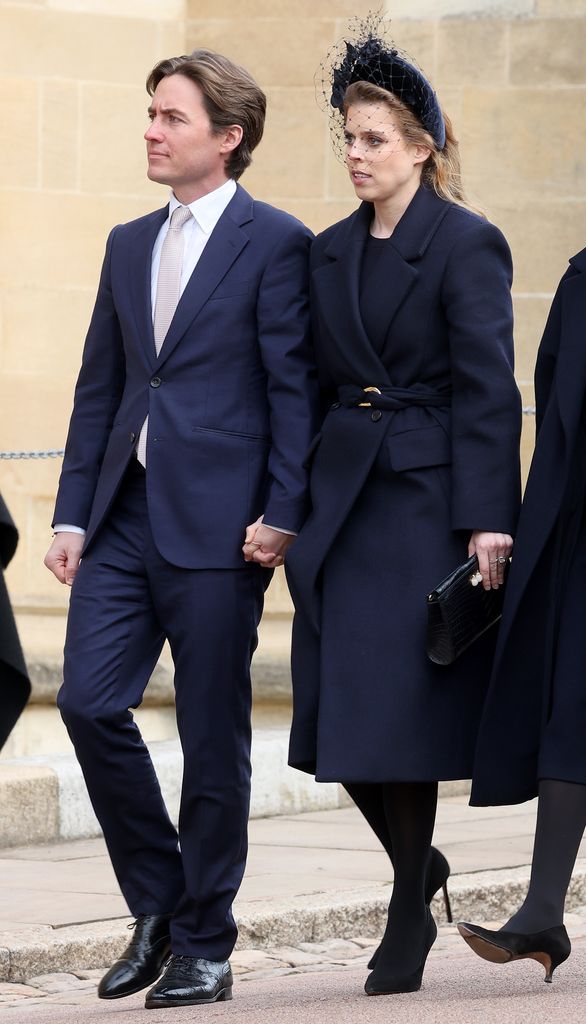 Princess Beatrice in navy with veiled headband with husband