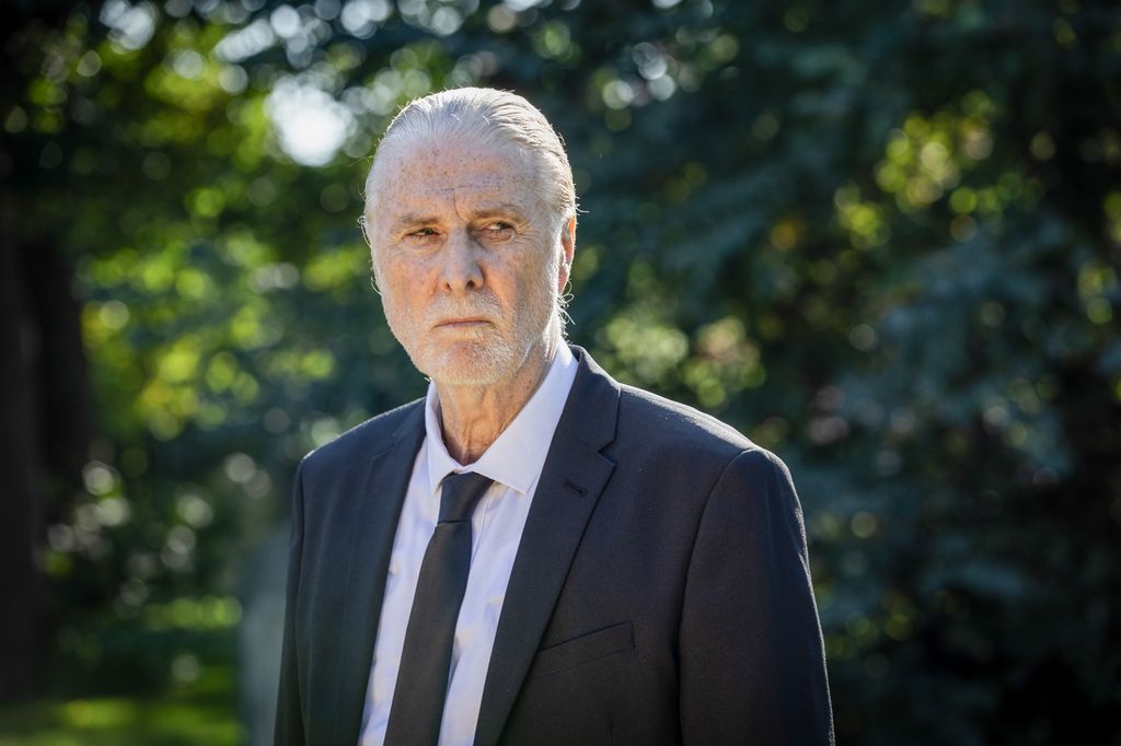 close-up of older man in black suit 