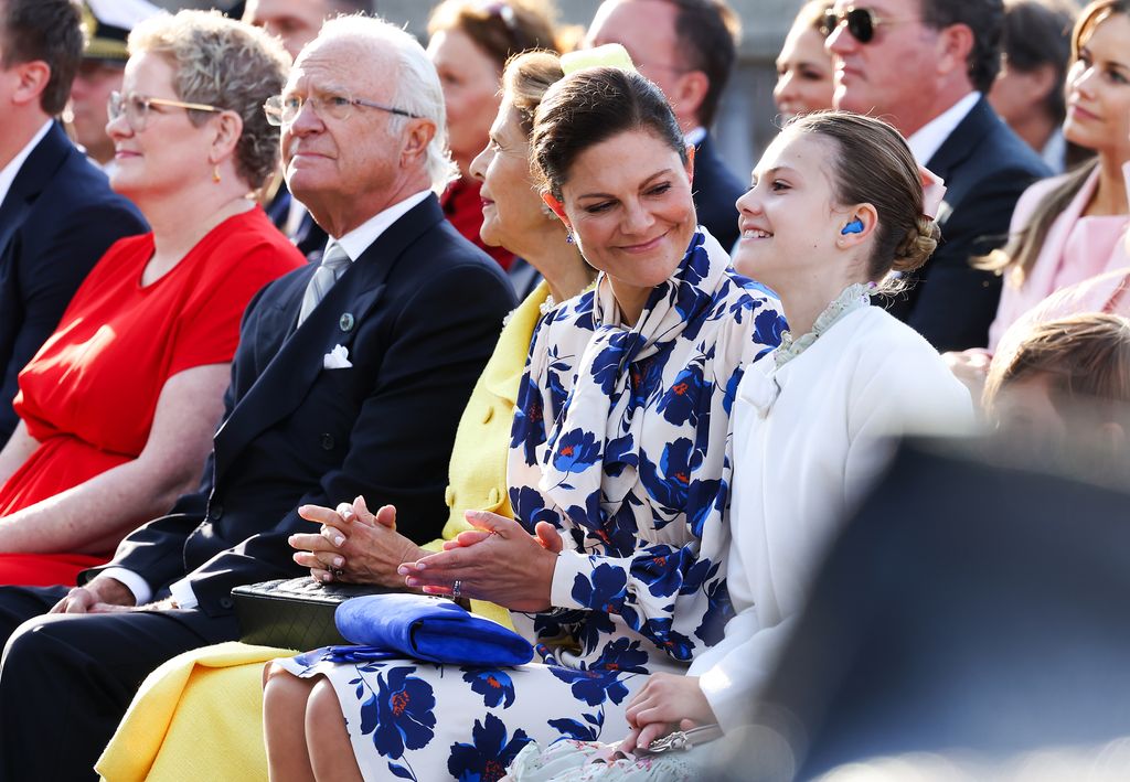 Crown Princess Victoria smiling at Princess Estelle at the jubilee concert
