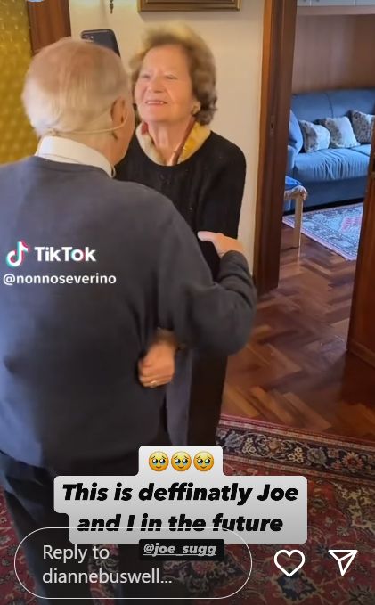 Two elderly people dancing together