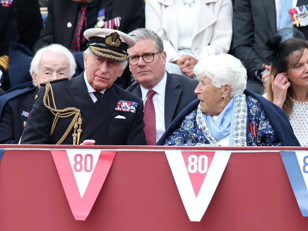 King Charles speaks to veteran with Keir Starmer behind