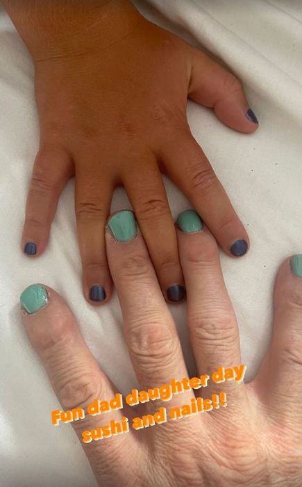 mike tindall and daughter hands with painted nails 