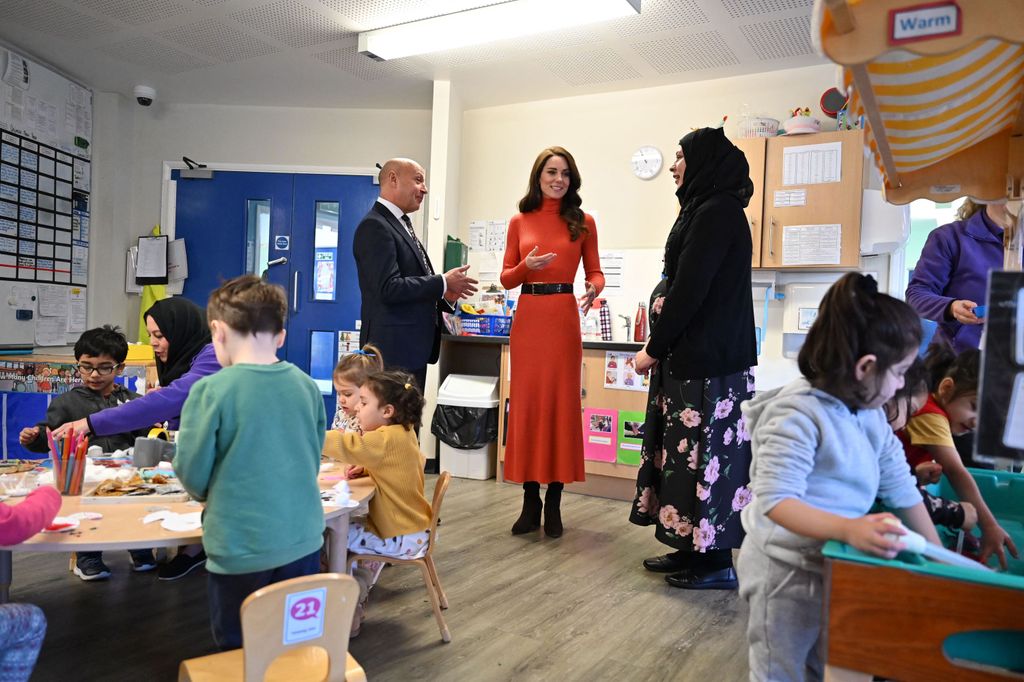 The Princess of Wales in nursery room with staff and children in orange outfit