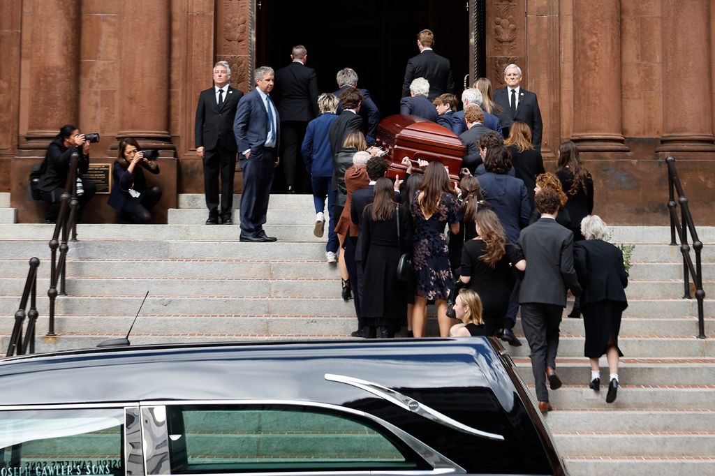 Ethel's family carries her casket into the cathedral