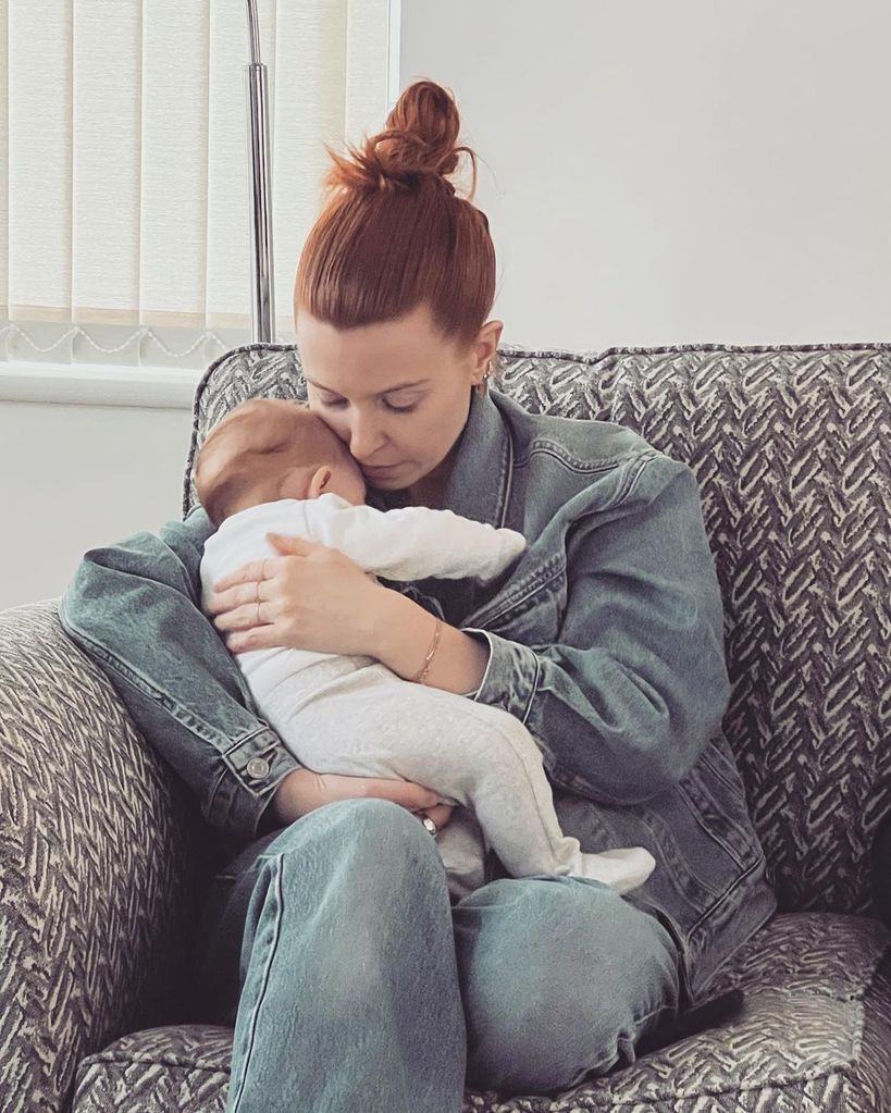 Stacey Dooley cuddled up on the sofa with baby Minnie