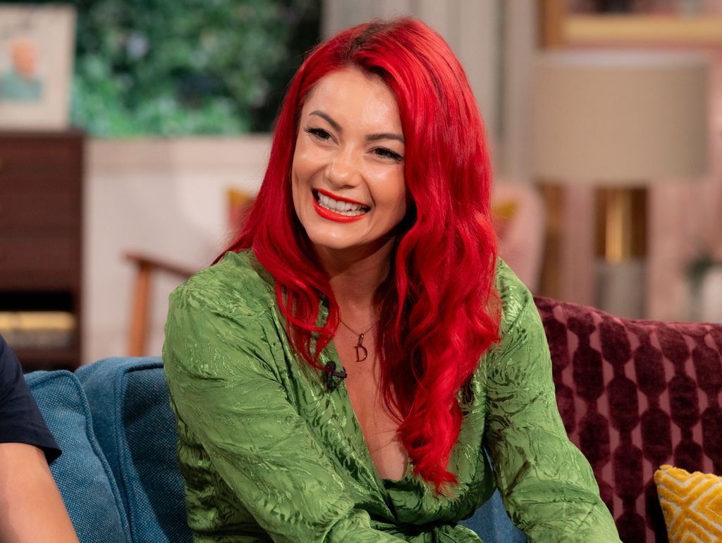 Dianne Buswell smiling in a green dress