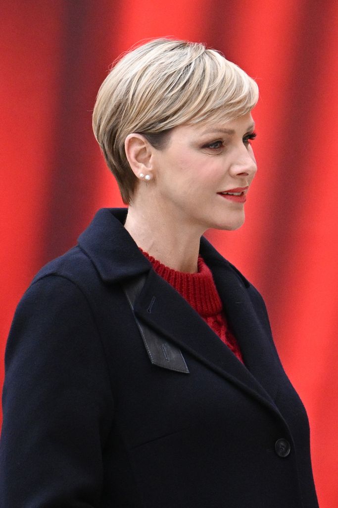 Princess Charlene in navy coat and red jumper