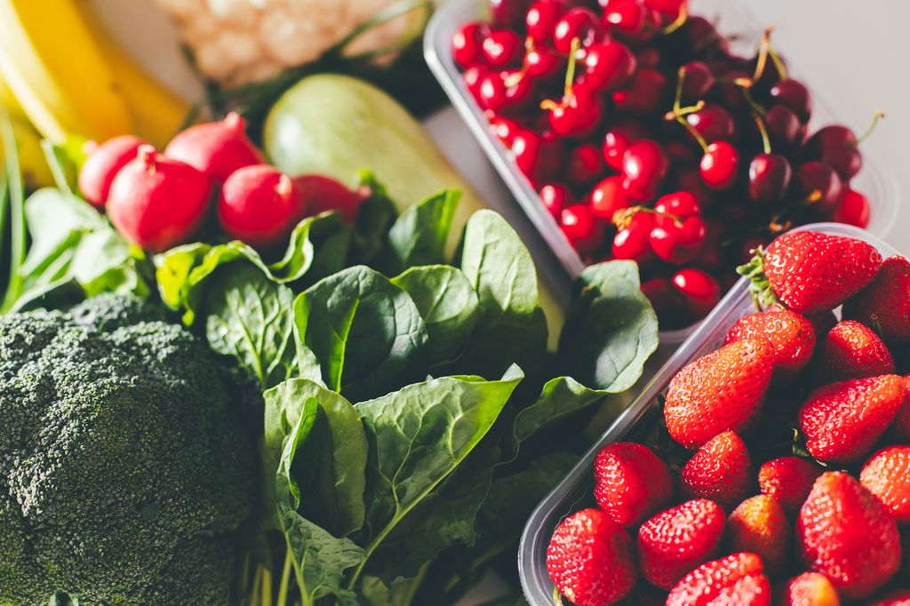 Top view of fresh garden organic vegetables, berries, fruits on a table 