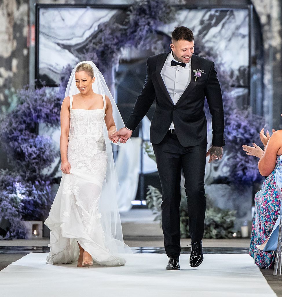 Jamie and Dave holding hands as they walked down the aisle after getting married