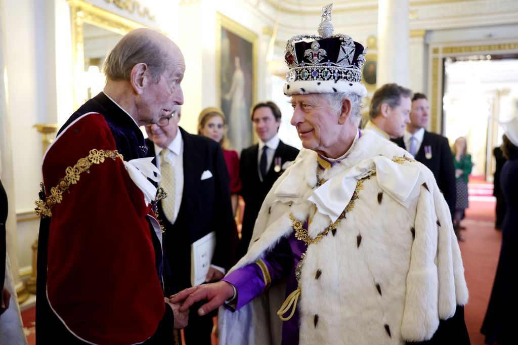 The Duke of Kent shaking hand of king charles wearing crown and robes