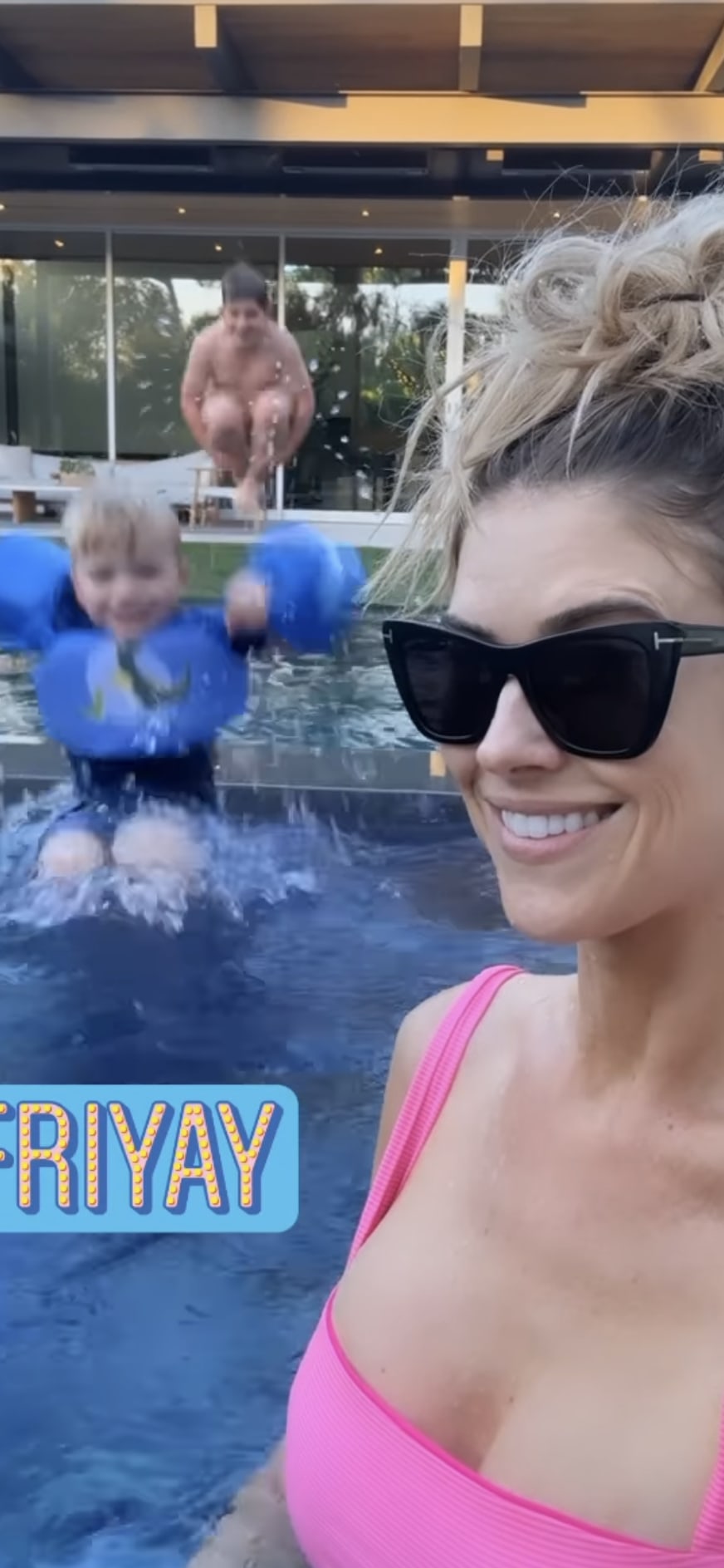 Christina Hall dazzles in a hot pink swimsuit as she plays with her boys in the pool 