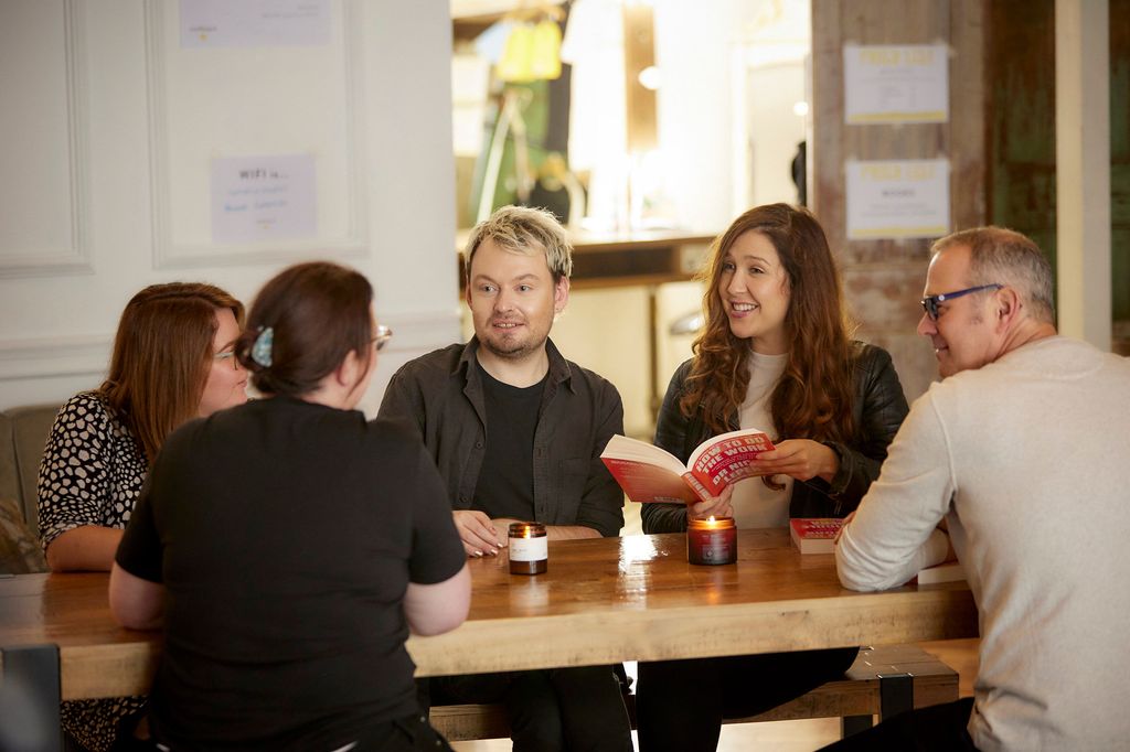 Group of people chatting around a table happily