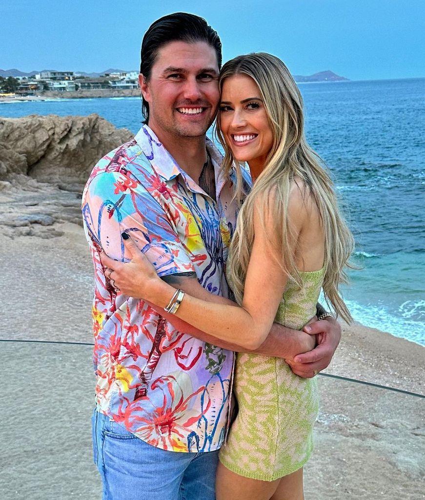 Christina and Josh Hall hugging on vacation