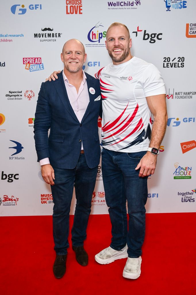 two men posing on red carpet 