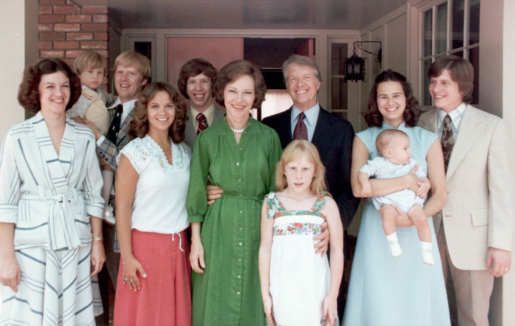 A portrait of President Jimmy Carter and his extended family. Left to right: Judy (Mrs. Jack Carter); Jason James Carter; Jack (John William Carter); Annette (Mrs. Jeff Carter); Jeff (Donnel Jeffrey Carter); First Lady Rosalynn Carter; daughter Amy Lynn Carter; President Carter; daughter-in law Caron Griffin Carter holding James Earl Carter IV; and son Chip (James Earl Carter III). 1977