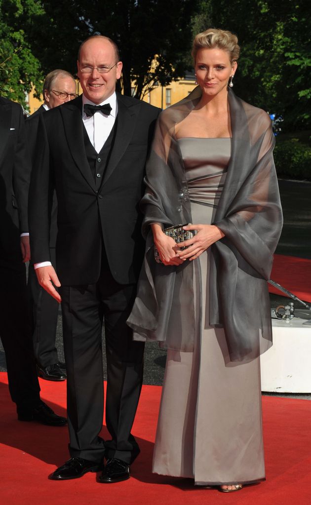 Prince Albert of Monaco in a suit and girlfriend Charlene Wittstock in a grey dress