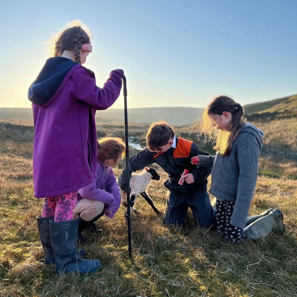 Amanda Owen shared a series of snaps of her children attending to the farm's new lambs