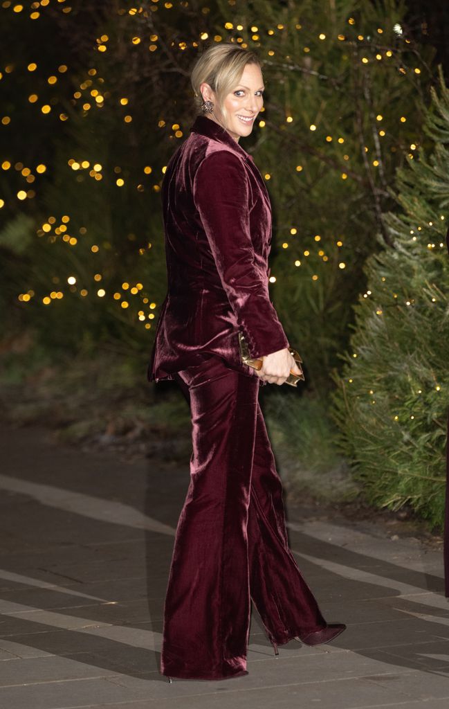 woman walking in burgundy velvet trouser suit