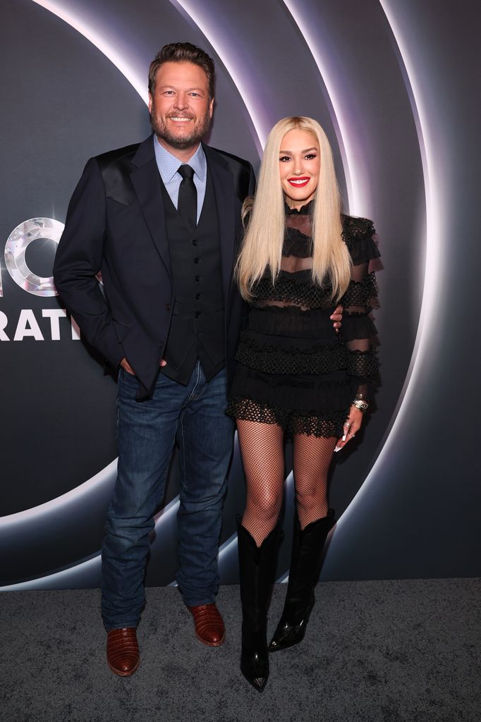 Blake Shelton and Gwen Stefani in black mini dress posed 