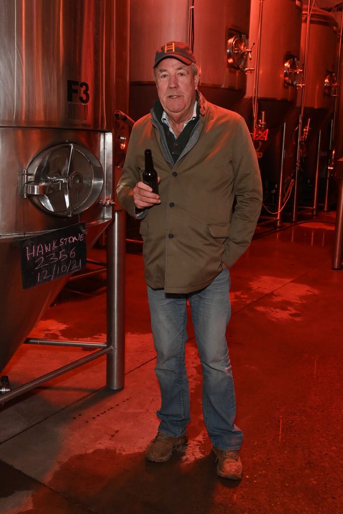 Jeremy Clarkson sipping a beer wearing a cap