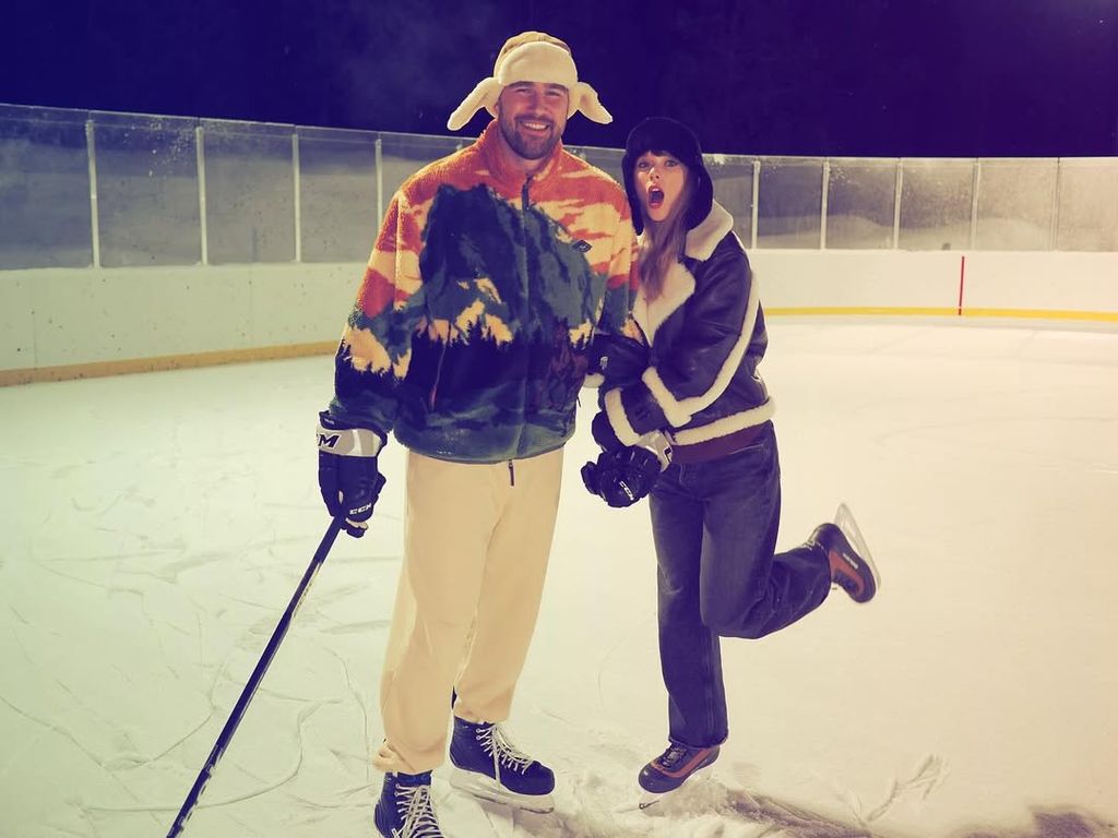 Traivs Kelce and Taylor Swift pose on an ice rink