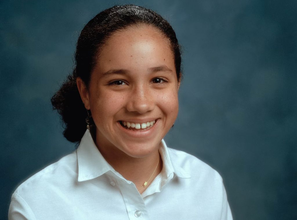 A young Meghan Markle's school photo - she sits in a white shirt