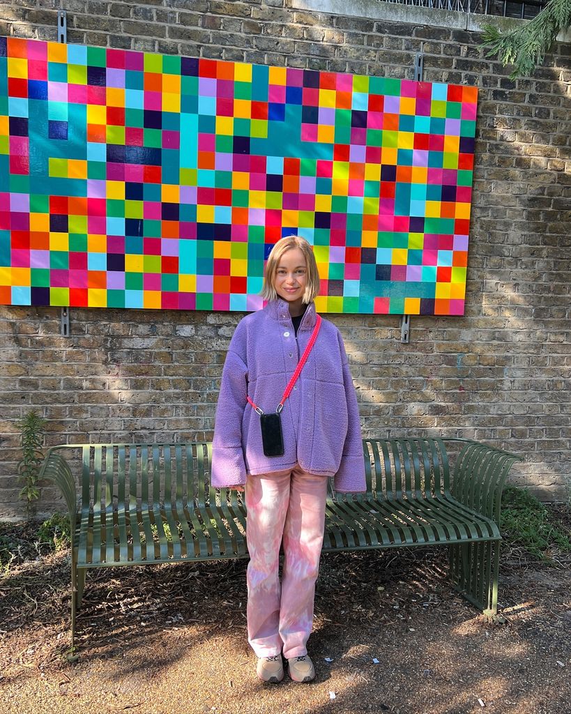 Amelia Windsor wearing a lavendar fleece and psychedelic pink jeans