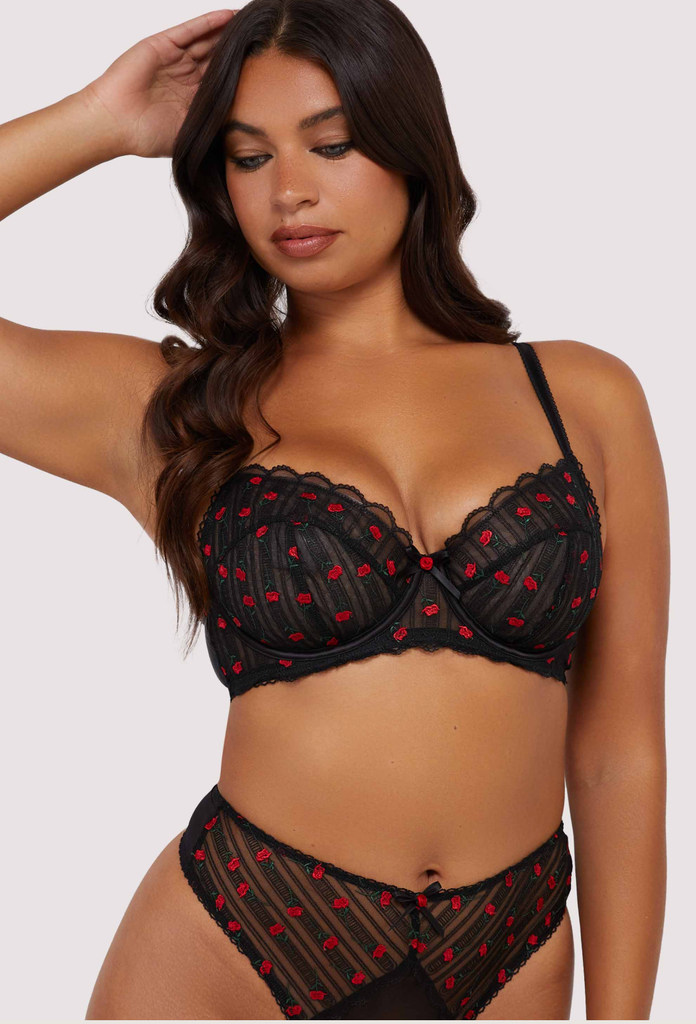 model in black bra with red rose motif