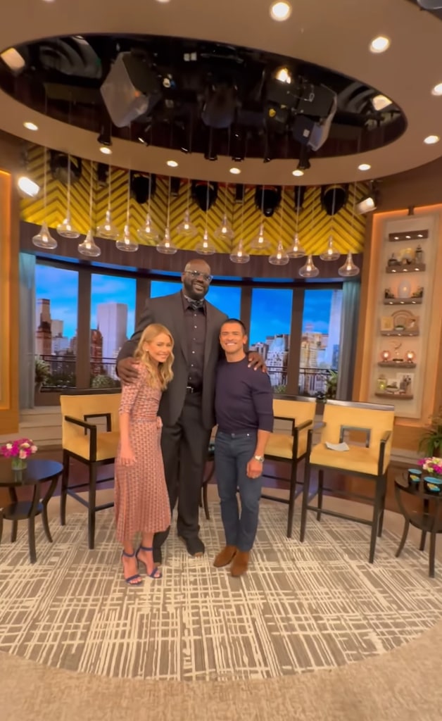 Kelly Ripa and Mark Consuelos posing with Shaq in the Live studios 