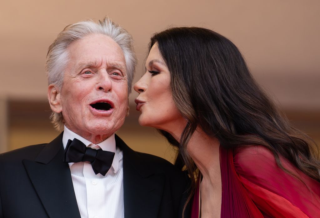 Michael Douglas in black tuxedo and Catherine Zeta-Jones in red dress