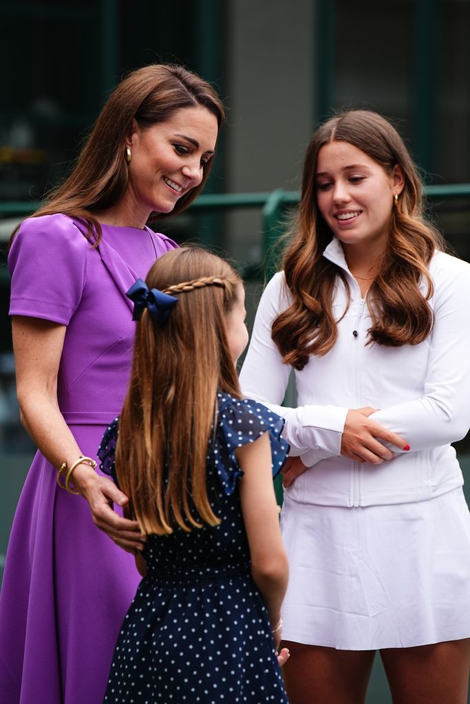 Catherine, Princess of Wales (2nd L) and Princess Charlotte (L) meet Flora Johnson (R) during a visit to the All England Lawn Tennis and Croquet Club in Wimbledon, south west London, on day fourteen of the Wimbledon Tennis Championships on July 14, 2024 in London, England. 