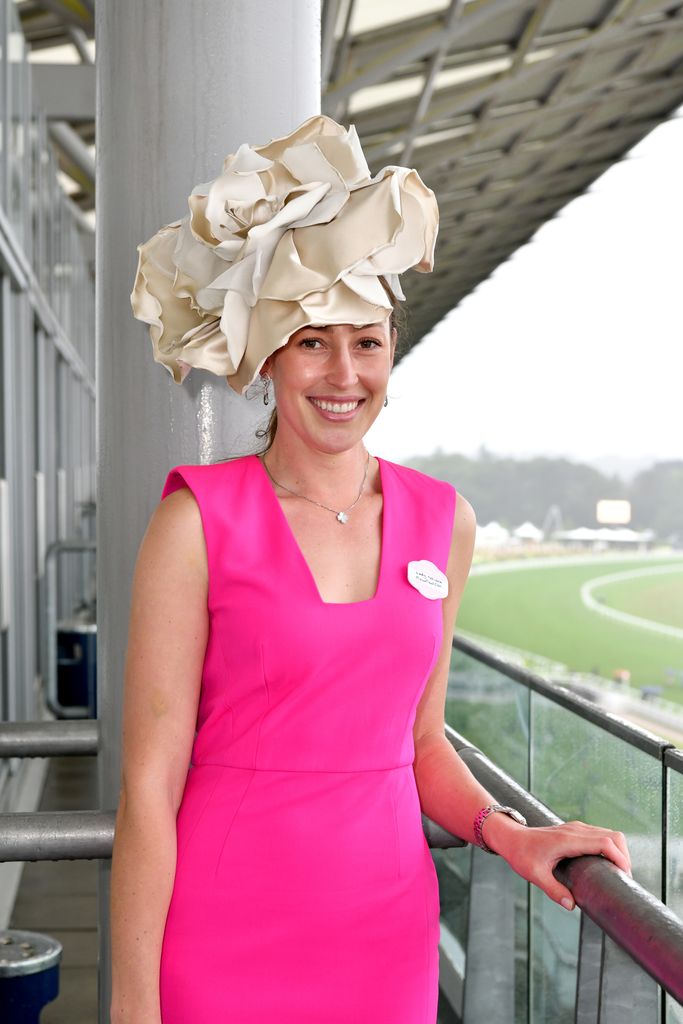 woman in bright pink dress and large hat