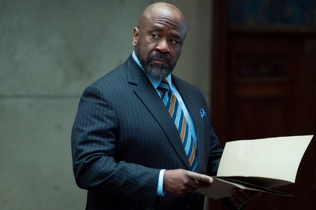 man in suit holding paper