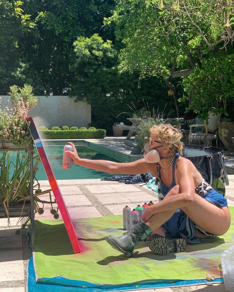 Sharon Stone wore a leopard print swimsuit and biker boots as she completed her latest artwork
