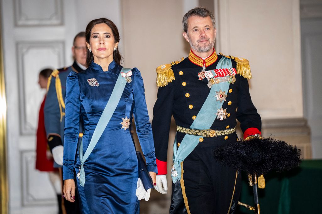 Crown Princess Mary in blue satin dress and Crown Prince Frederik in military uniform