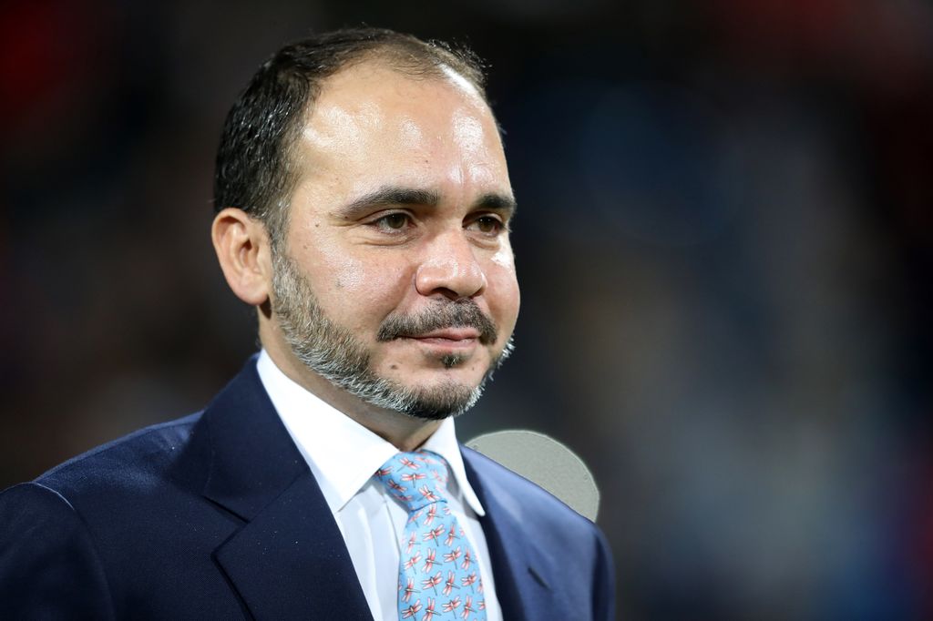 Prince Ali in a blue suit at a football match