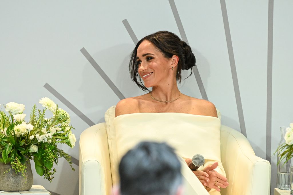 Meghan Markle smiling on stage at Archewell mental health summit