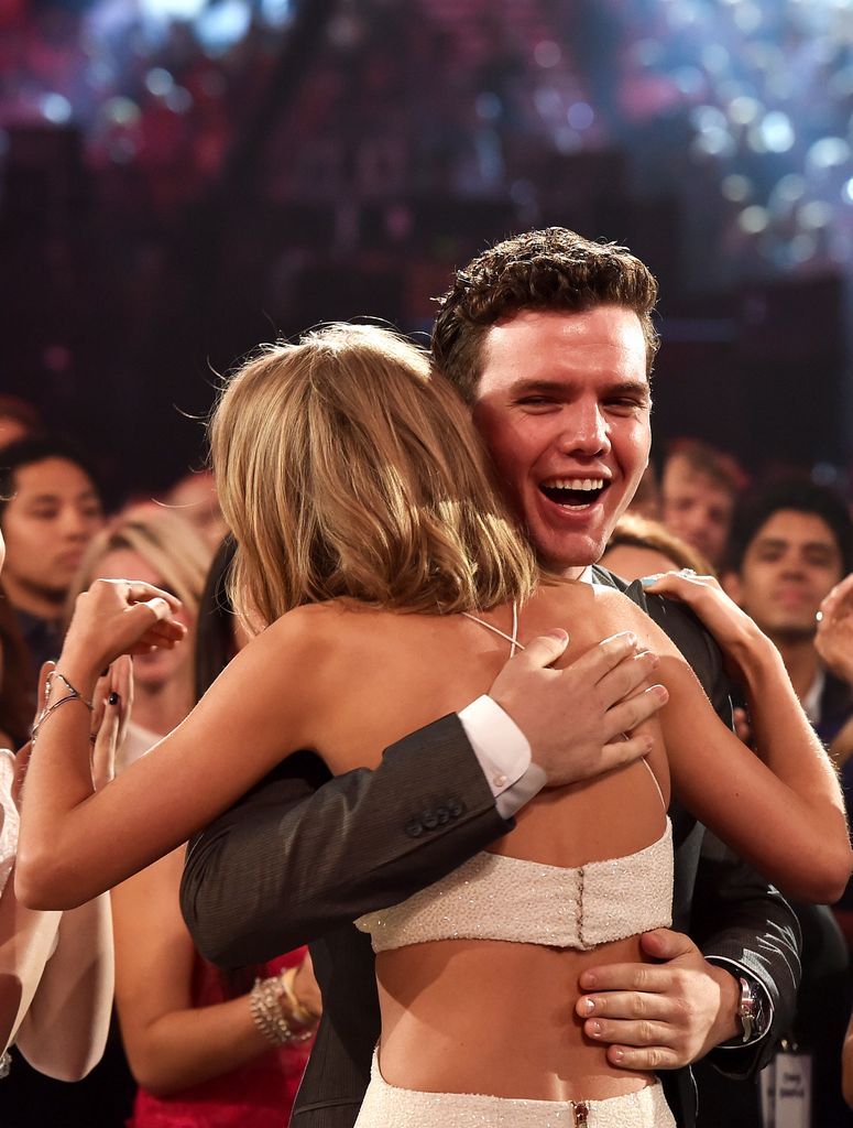 Musician Taylor Swift (L) embraces brother Austin Swift after winning the Top Artist award at the 2015 Billboard Music Awards at MGM Grand Garden Arena on May 17, 2015 
